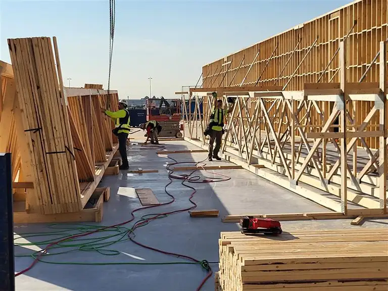 Nuframe team craning roof trusses for a commercial project at YVR in Richmond BC.